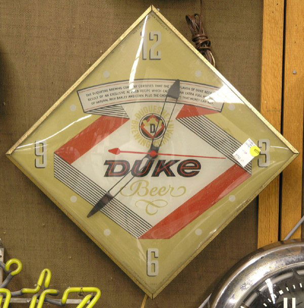 Duke Beer Bubble clock Schlitz sign: (lot of 2) Backlit Duke Beer advertising bubble clock, 21.5''h, backlighting on one side only, currently operates together with a Schlitz Beer neon sign with tube losses, 25''w