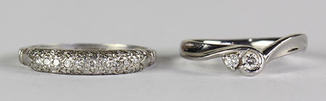 (Lot of 2) Diamond and platinum rings: (Lot of 2) Diamond and platinum rings comprised of one ring, featuring (2) full-cut diamonds, weighing a total of approximately 0.08 ct., set in a platinum mounting, size 4 1/2; together with one band