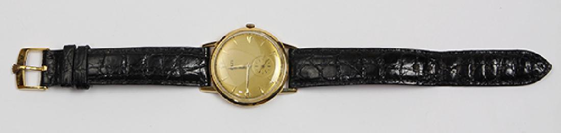 18k yellow gold wristwatch: 18k yellow gold wristwatch Dial: round, golden, applied baton and arrow hour markers, black outer minutes track, sunken subsidiary seconds dial at 6, gold tone dauphine hands, Rolex (Not Rolex) Moveme