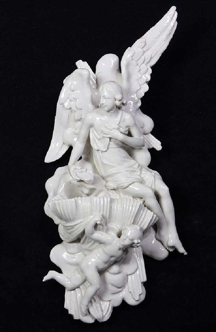 Continental Blanc de Chine wall sculpture: Continental Blanc de Chine wall sculpture, modeled as a winged figure perched on an open clam shell, supported by a putto at the base, 17"h x 6.5"w x 4"d