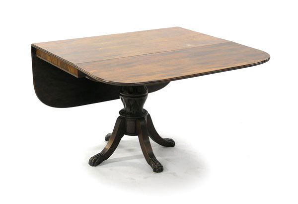 Federal Duncan Phyfe style table, 1820: Late Federal mahogany dining table after Duncan Phyfe. The rectangular top flanked by D-end drop-leaves, above a beaded frieze supported by an acanthus leaf carved pedestal base, terminating on 4 legs
