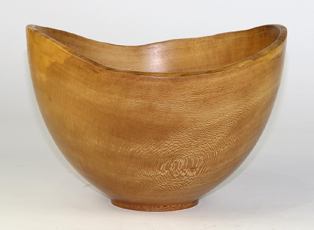 Ken Goodrich wood turned bowl executed in sycamore: Ken Goodrich wood turned bowl executed in sycamore, the naturalistic free edge top continuing to the tapering body, and rising on a circular base signed and dated 97, 7.5"h x 10.5"w