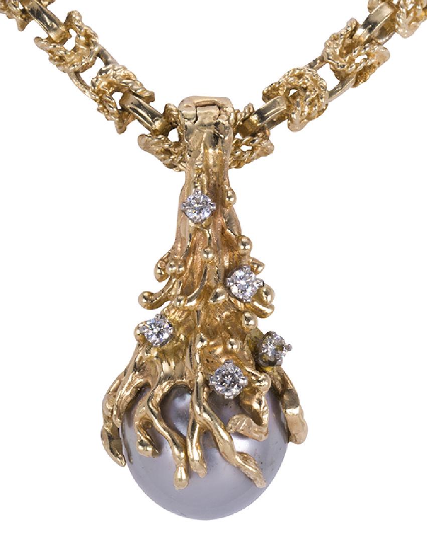 Cultured pearl, diamond and yellow gold: Cultured pearl, diamond and yellow gold pendant-necklace featuring (1) Tahitian gray cultured pearl. measuring approximately 12.3 mm, accented by (5) full-cut diamonds, weighing a total of approximate