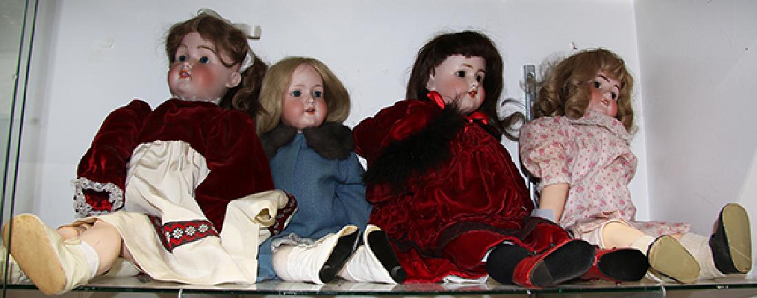 (lot of 4) Porcelain bisque head doll group: (lot of 4) Porcelain bisque head doll group, each with glass eyes, open mouth with visible teeth, articulated composite bodies, consisting of an Armand Marsielle example, a Simon and Halbig example, l