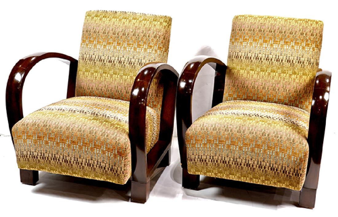 Pair of French Art Deco club chairs: Pair of French Art Deco club chairs, each having polychrome upholstery, with shaped arms, and rising on square legs, 31"h x 27"w x 24"d