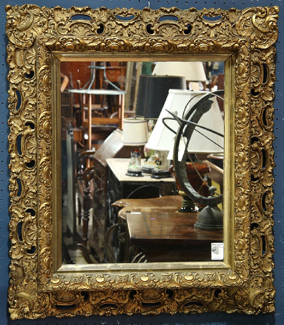 Rococo style giltwood mirror: Rococo style giltwood mirror, 19th century, with pierced and relief-decorated frame, 31.5"h x 28"w