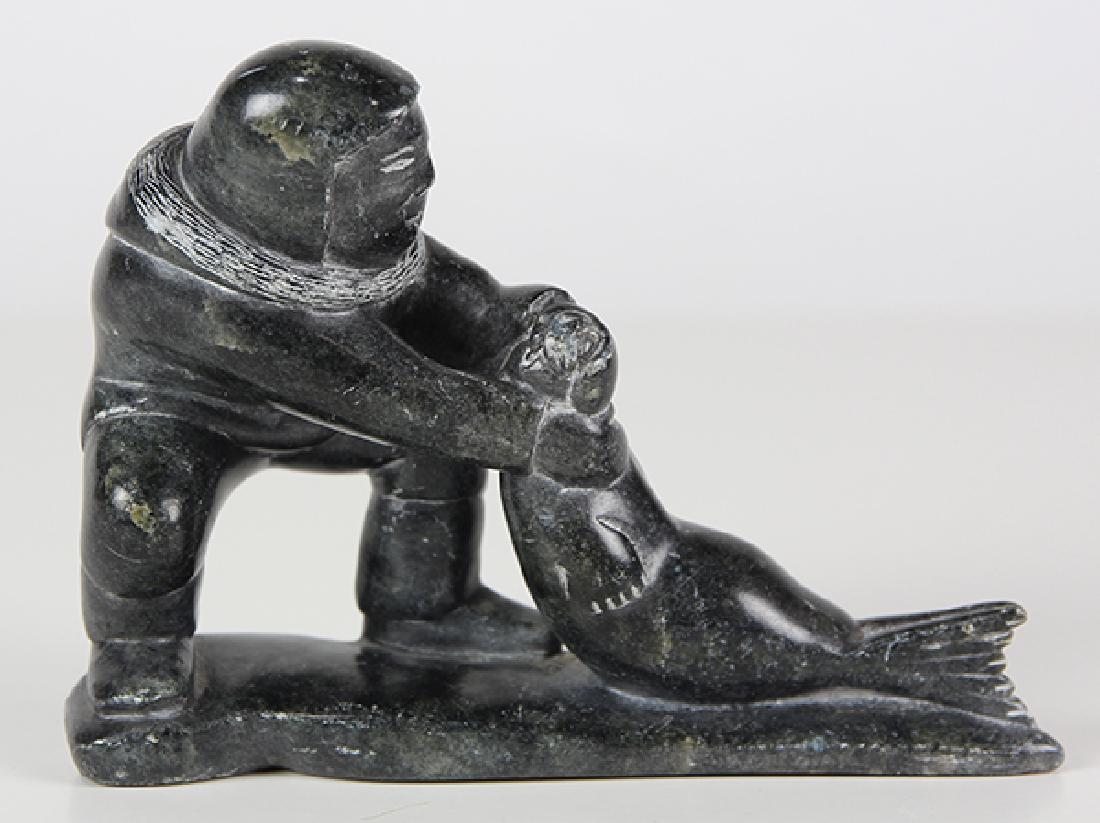 Inuit carving by Adamie Anautak: Inuit carving by Adamie Anautak, of a hunter hauling a seal, Inukjuak c. 1986