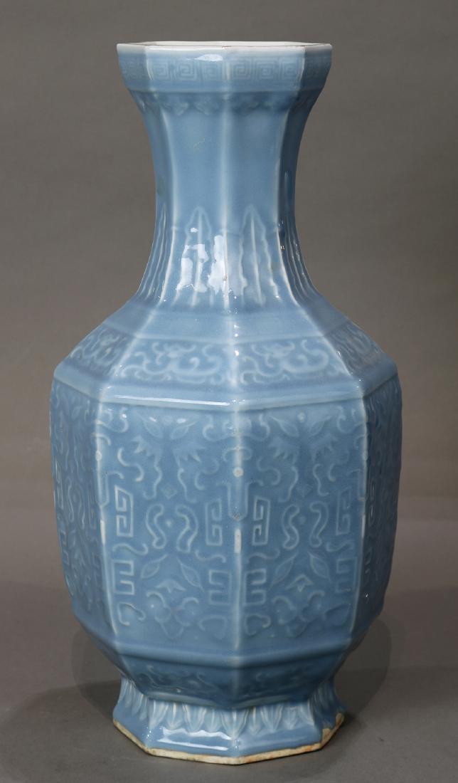 Chinese Blue Monochrome Vase: Chinese blue monochrome porcelain vase, the trumpet neck with stiff leaf bands, the shoulder with dragon panels, and the body with stylized scroll pattern, base with apocryphal Qianlong mark, 16.5"h