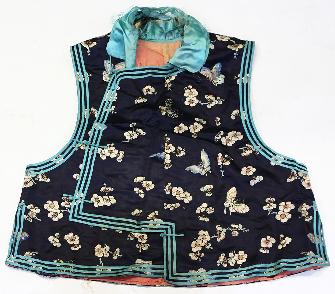 Chinese Woman's Blue Silk Vest: Chinese woman's embroidered vest, with a blue satin silk ground embroidered with butterflies amid prunus, 24.5"h