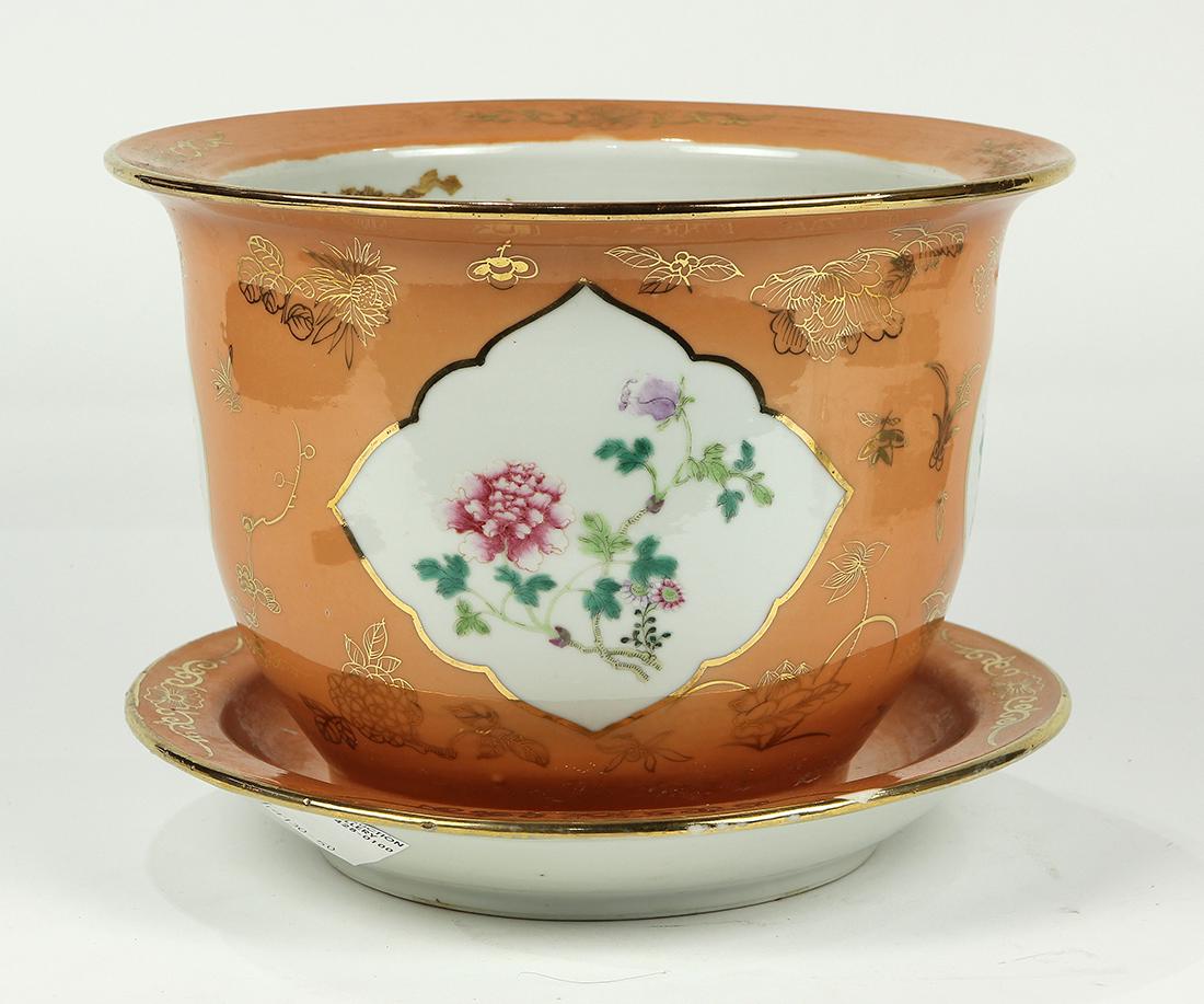 Chinese Porcelain Planter: Chinese enameled porcelain planter and underdish, with floral reserves set agains a coral ground with gilt blossoms, 10.6"w