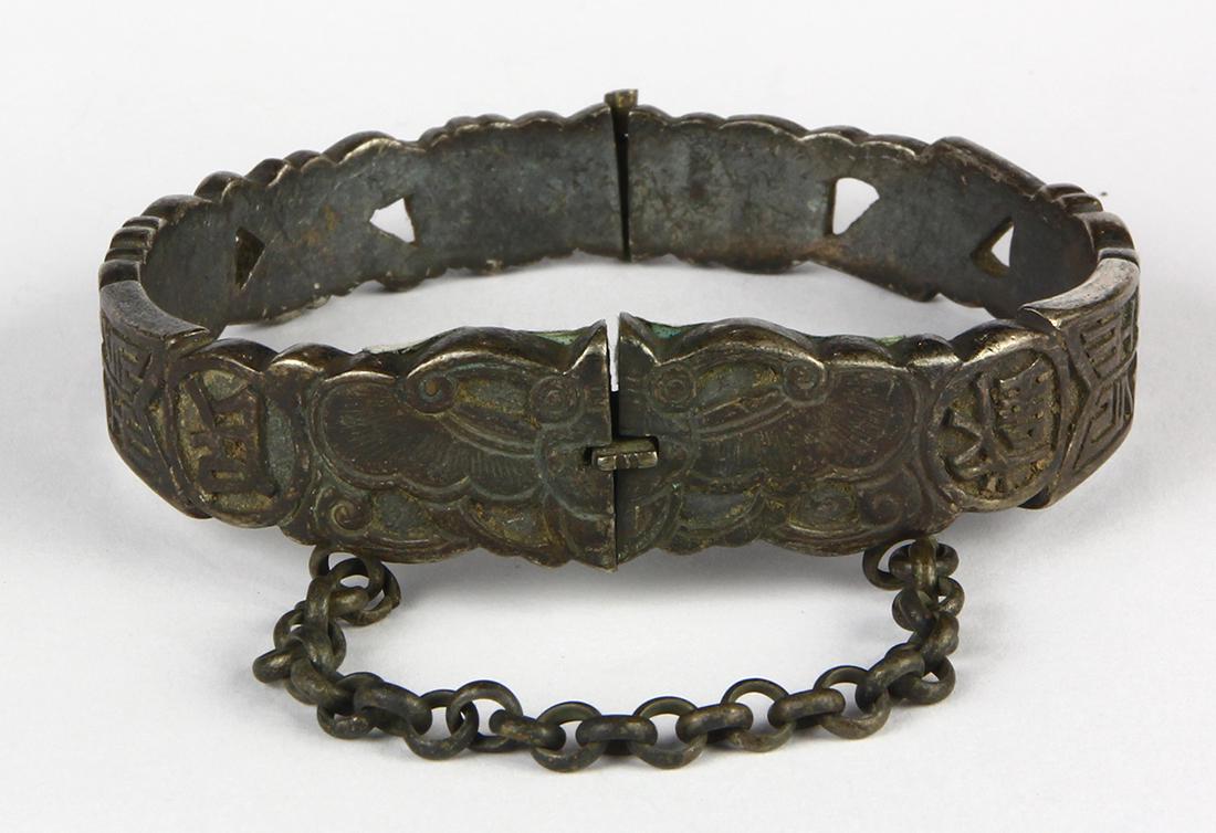 Chinese silver bracelet: Chinese silver bracelet the silver butterfly and symbol motif, hinged bangle bracelet with safety chain, measures approximately 15 mm to 10 mm in width, weighing 71.67 grams. Note: hinge is broken