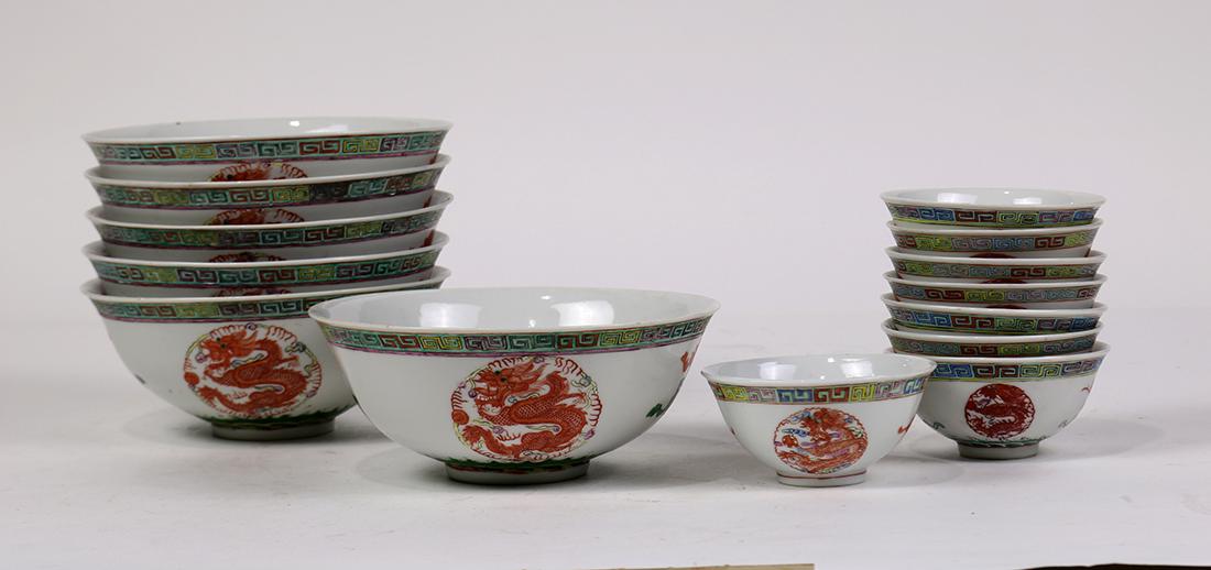 Chinese Porcelain Bowls/Cups, Dragon/Phoenix: (lot of 13) Chinese porcelain bowls and cups, each with dragon and phoenix roundels alternated by bats suspending coins, base with apocryphal Guangxu mark, 6.5"w; Provenance: Estate of Reynold Tom of 
