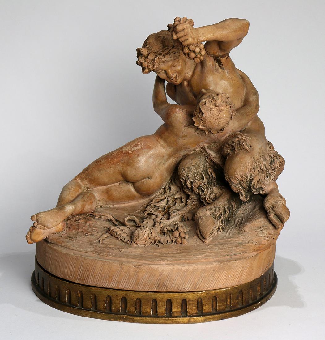 Continental terra cotta figural sculpture of a: Continental terra cotta figural sculpture of a bacchanalian scene, the satyr depicted holding a grape cluster above the mouth of the reclining nude, her arms wrapped around his torso, the whole rising