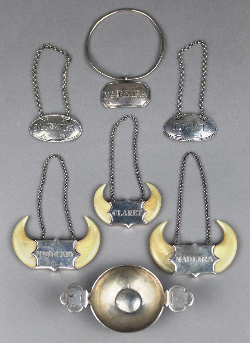 (lot of 7) Wine/Spirit related articles, consisting of: (lot of 7) Wine/Spirit related articles, consisting of sterling name tags/plates, including (3) Madeira, Claret, Burgundy, and Port, 3"w; together with a Continental silver wine taster; approx total w