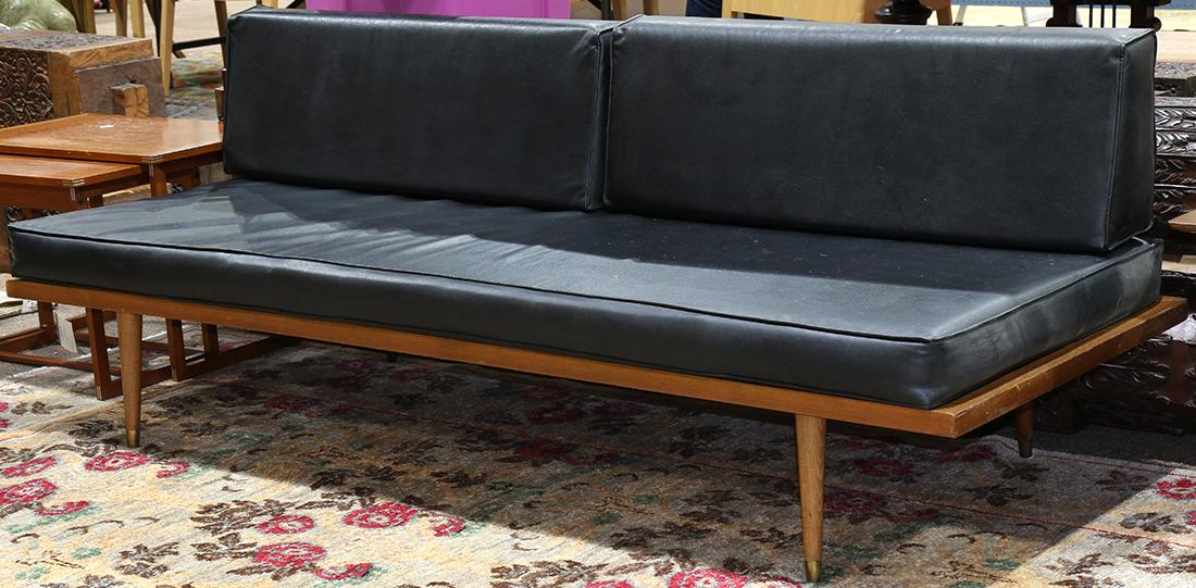Modern Adrian Pearsell style sofa, having black: Modern Adrian Pearsell style sofa, having black upholstery, above a wood and black painted metal frame, and rising on tapered legs terminating on brass caps, 27.5"w x 72"w x 30"d
