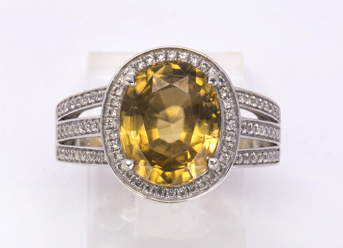 Zircon, diamond and 14k white gold ring: Zircon, diamond and 14k white gold ring Centering (1) oval-cut yellow zircon, weighing approximately 6.00 cts., accented by (36) full-cut diamonds, weighing a total of approximately 0.50 ct., set in a