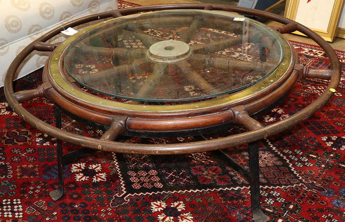 Ships wheel: Ships wheel, mounted as a table, having a spoke form with a later glass top and rising on a metal base, 17"h x 50"w
