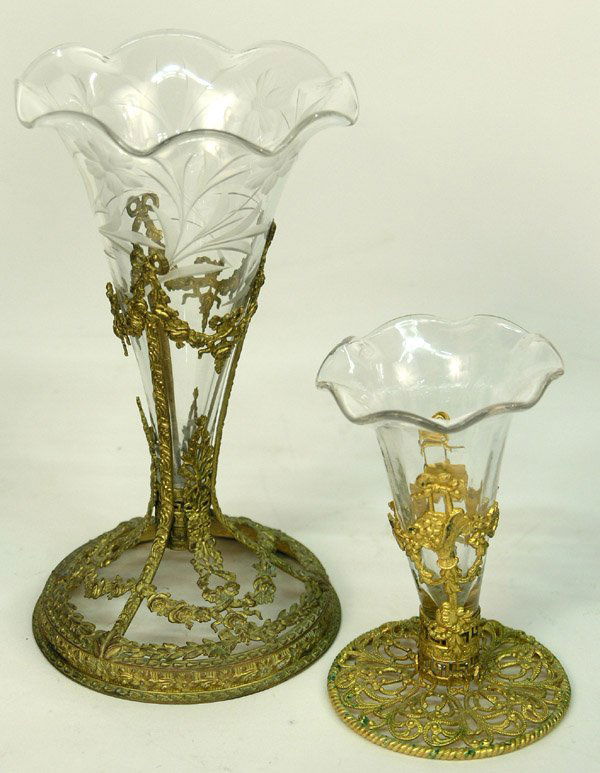 Continental gilt glass single epergnes: (lot of 2) Early 20th century Continental gilt metal and cut glass single epergnes, the first with exquisite gilt metal floral swags forming the frame, the glass trumpet cut with a floral and foliate