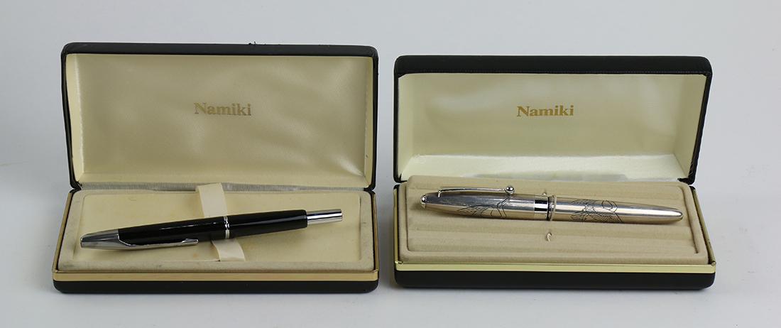 Japanese Namiki fountain pen group: (lot of 2) Japanese Namiki fountain pen group, consisting of a sterling silver example, the barrel and cap decorated with a crane, with original box, pen 5.5"l; together with an example having a black