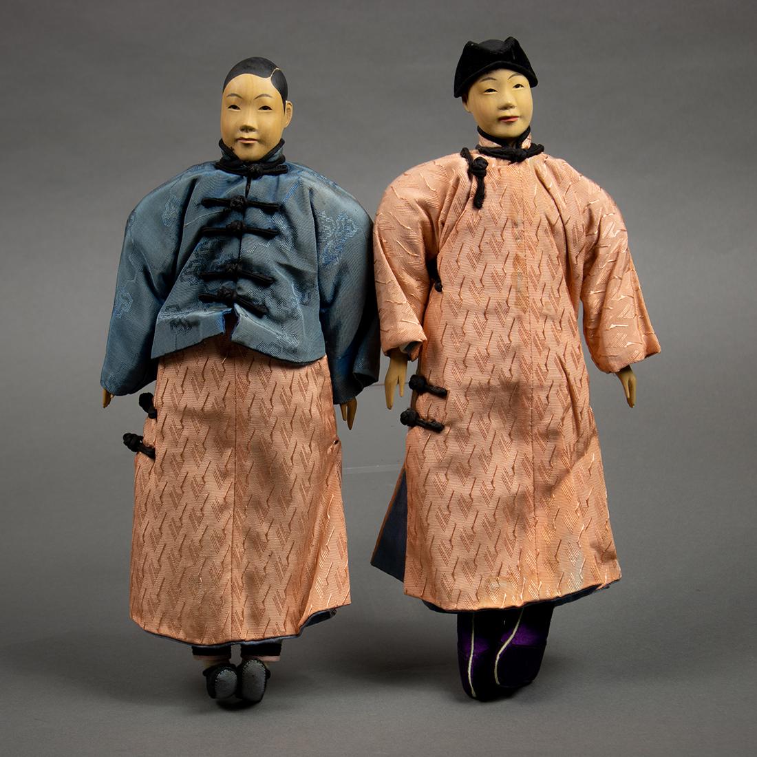 Chinese Door of Hope Dolls, Couple in Pink: Pair of Chinese Door of Hope dolls, featuring a young couple each in a pink damask robe, the man with a short blue coat, 11.75"h
