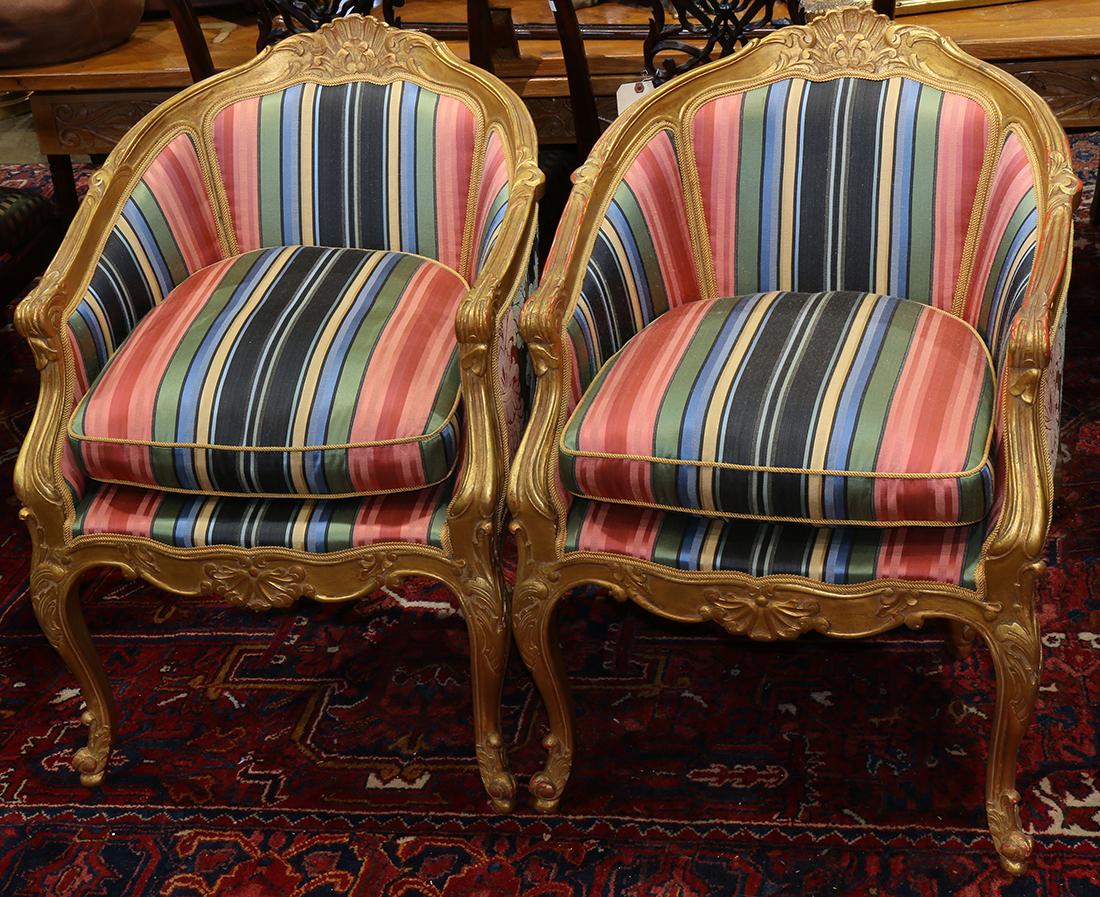 Louis XV style giltwood carved bergeres, having a fan: (lot of 2) Louis XV style giltwood carved bergeres, having a fan carved crest above the three part back with silk striped upholstery and nail head trim, and rising on cabriole legs, 35"h x 25"w