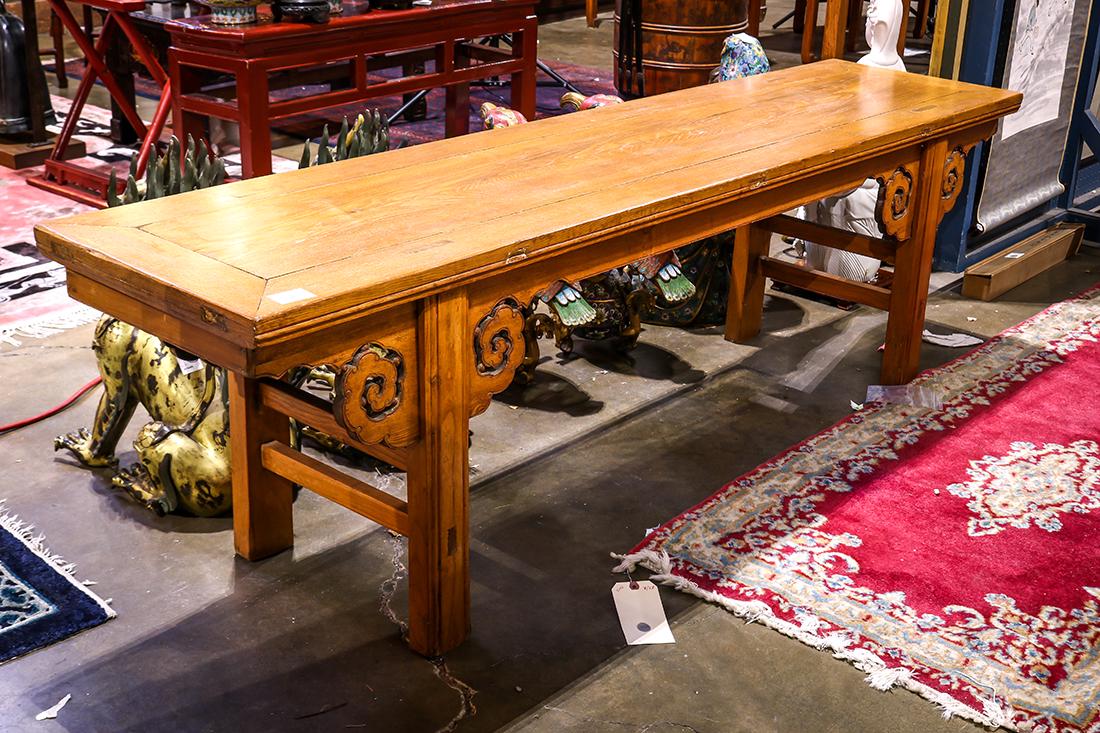 Chinese Wooden Low Table/Bench: Chinese wooden altar table, now a low table/bench, inset with a single floating panel, with a bead edge apron and ruyi head spandrels, 74.25"l