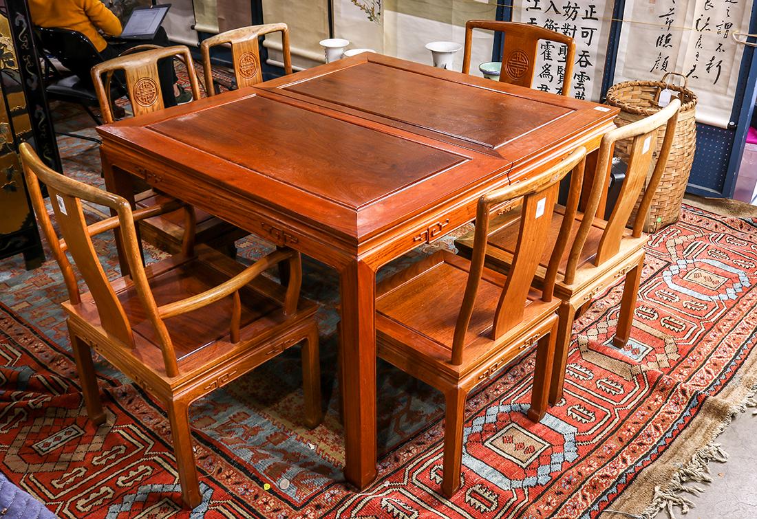 Chinese Dining Table And Chairs: (lot of 7) Chinese dining table and six chairs, the rectangular table with two additional leaves, with a scroll apron and raised on supports with hoof terminals; together with chairs centered with a S