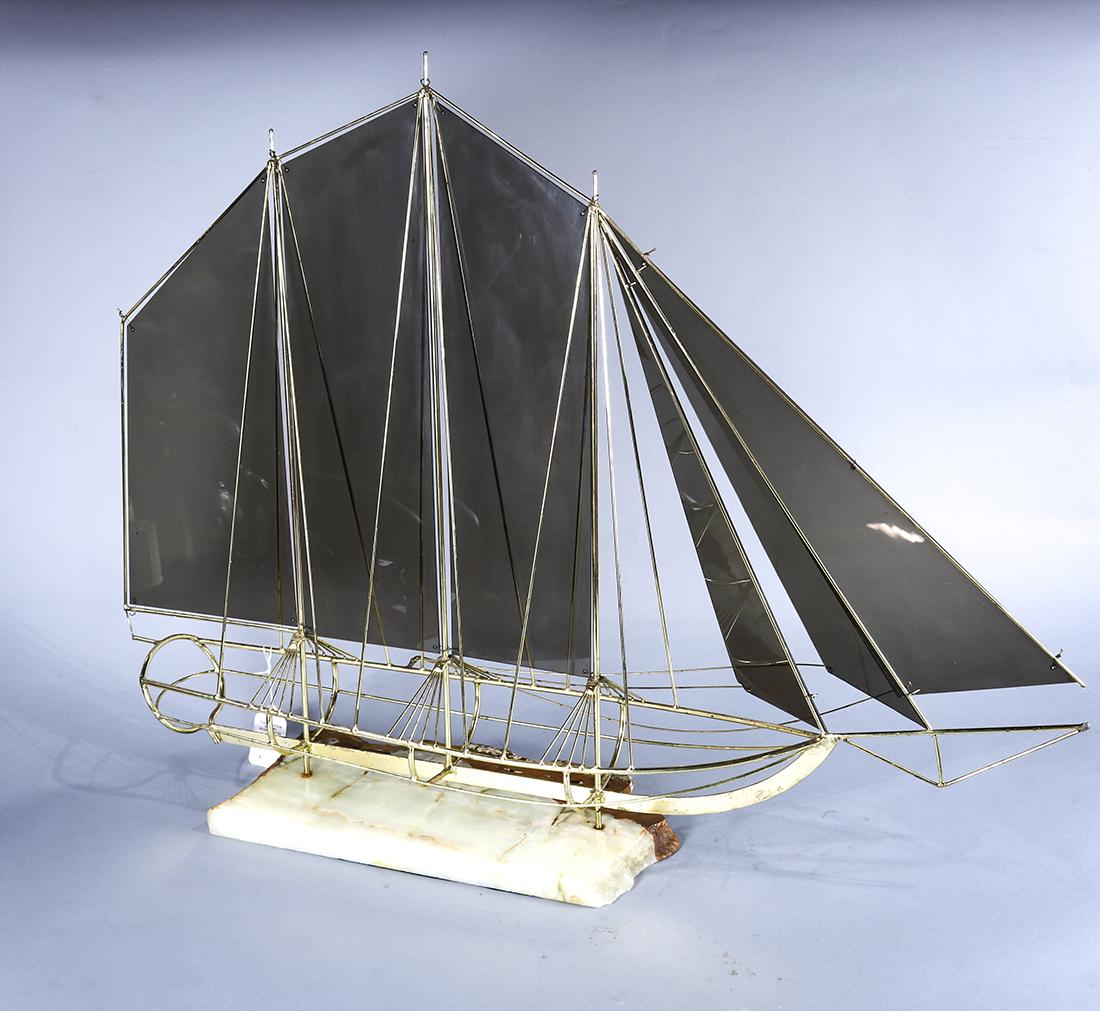Mid century modern brass sail boat sculpture: Mid century modern brass sail boat sculpture, the sails executed in smoked gray plastic, rising on a marble base, 31"h x 40"w x 9"d