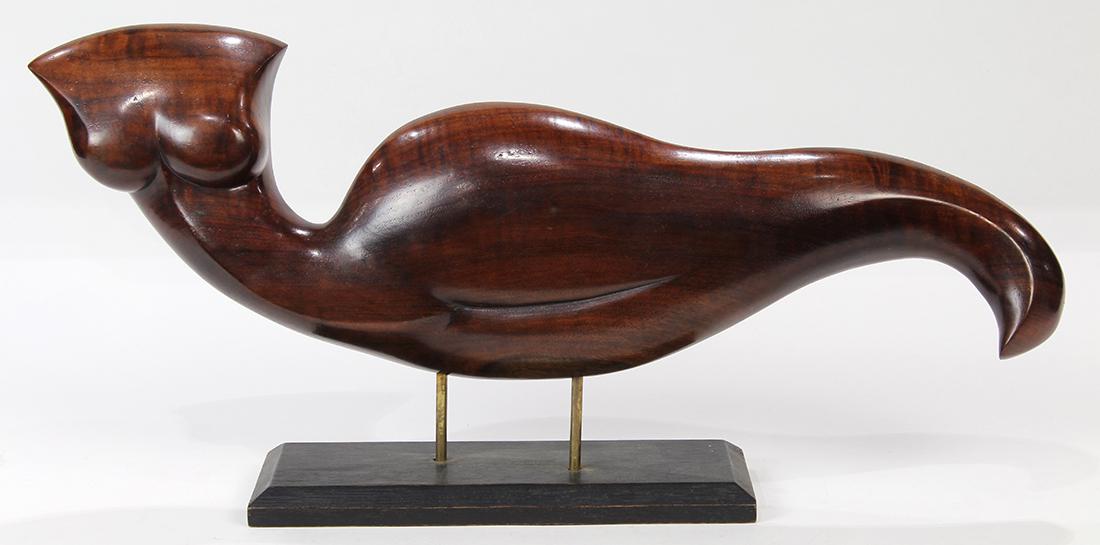 Moderne figural wood carved sculpture: Moderne figural wood carved sculpture, depicting a stylized nude female executed in figured walnut, and rising on an ebonized base, 10"h x 21"w