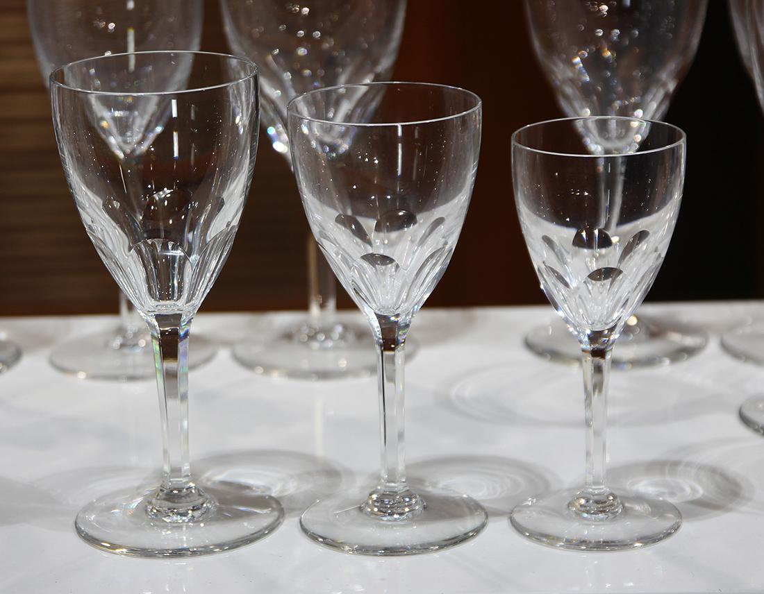 Baccarat stemware group: (lot of 79) Baccarat stemware group, in the "Genova" pattern, each having a faceted stem, consisting of (14) water goblets and (23) red wine glasses, (26) white wine glasses, and (16) cordials, each w