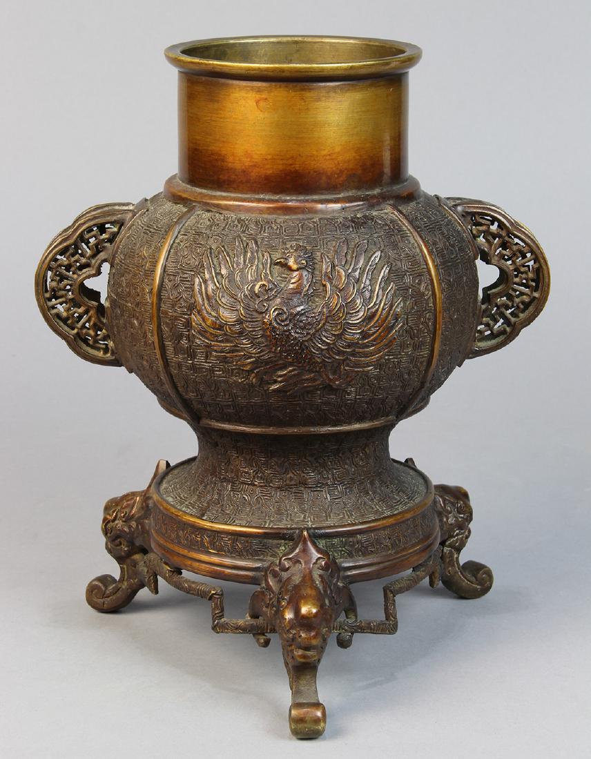 Japanese Bronze Japanese Usubata Ikebana Vase: Japanese bronze usubata ikebana vase, 1818-1830, bulbous body with molded phoenix, pierced work handle on either side, on zoomorphic tripod, base marked 'Dai Nippon Bunsei Nen', 10.5"h
