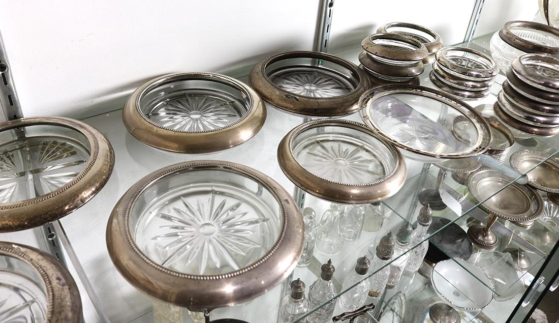 (lot of 21) Sterling silver and glass coasters, in: (lot of 21) Sterling silver and glass coasters, in various sizes and associated patterns, largest: 7"dia.