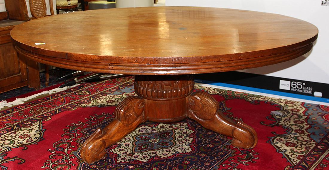 David Smith & Co. British Colonial style dining table: David Smith & Co. British Colonial style dining table, having a carved pedestal base accented with a carved figural and floral frieze, and rising on outswept legs, 29.5"h x 69.5"w