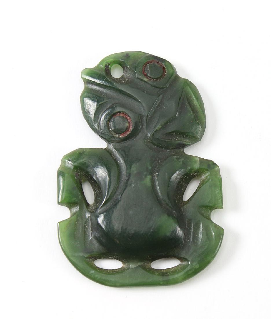 Maori or Maori-style nephrite pendant, traces of red: Maori or Maori-style nephrite pendant, traces of red in the eyes, flat and glossy-smooth back but sharp at edges, 2"h