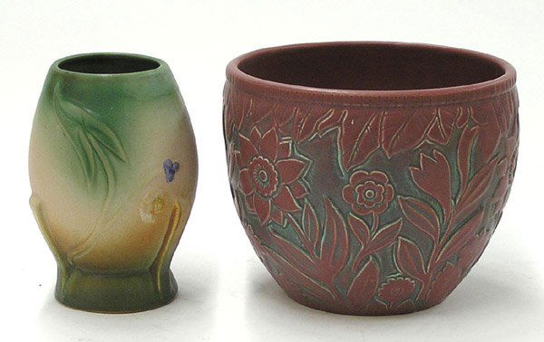 Weller art pottery jardiniere vase: Weller art pottery jardiniere in maroon matte glaze with molded sunflower pattern, 8'' and a Weller art pottery vase with molded begonia decoration 8''