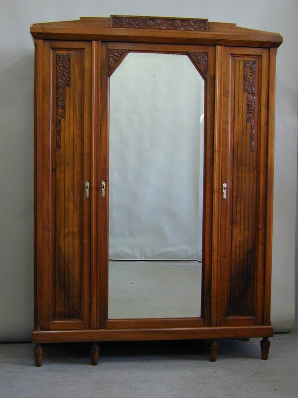 French Art Deco walnut bedroom set: French Art Deco carved walnut bedroom suite, circa 1925, including a three door armoire with central mirrored door, 83.75''h x 60''w x 19''d; bedstead and marble top bedside cabinet