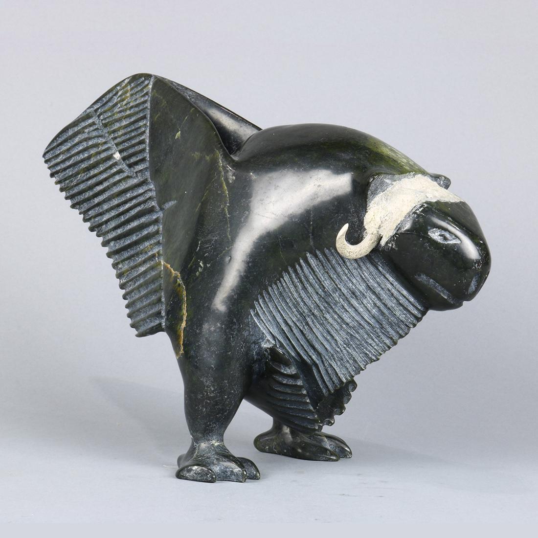 Inuit carved sculpture of a mythical beast, executed in: Inuit carved sculpture of a mythical beast, executed in variegated green stone, unsigned, retains label to underside, 8"h x 12"w