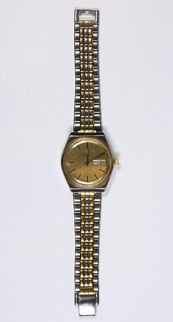 Omega Seamaster stainless steel wristwatch: Omega Seamaster stainless steel wristwatch Dial: round, gold tone, applied baton hour markers, black outer minutes and seconds track, apertures at 3:00 for day (Spanish) and date, gold tone and black