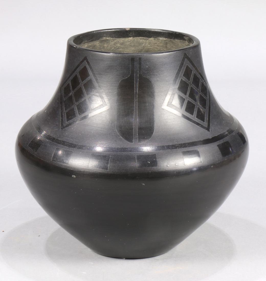 Large San Ildefonso Pueblo blackware jar, 1920's,: Large San Ildefonso Pueblo blackware jar, 1920's, signed "Marie", having diamond grid and feather motifs at the rim, 8.5"dia.