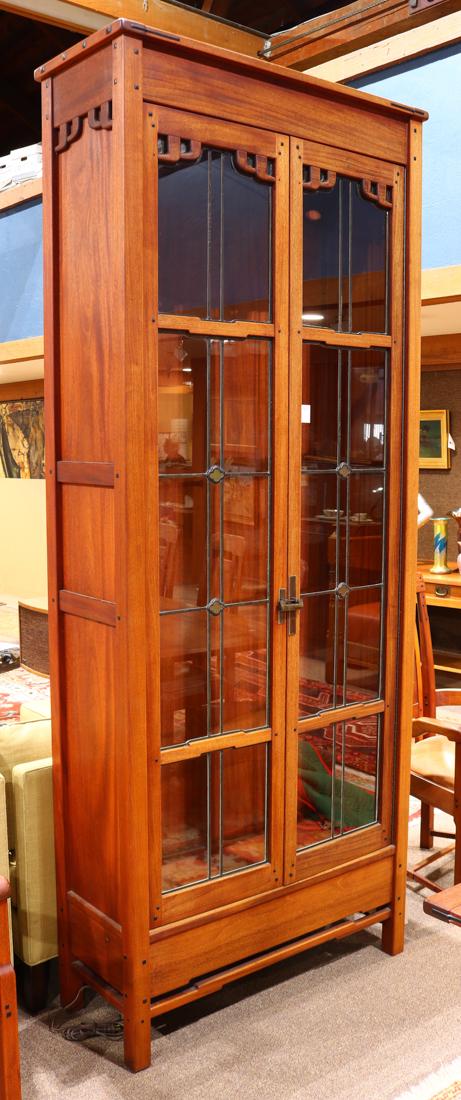 Large custom designed Greene and Greene style china: Large custom designed Greene and Greene style china cabinet, executed in the Japanese taste, the well executed case with ebony dowels and splines, centering the double leaded glass doors having reticu