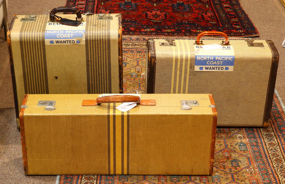 (lot of 3) Mid-Century Modern suitcases: (lot of 3) Mid-Century Modern suitcases, each executed in striped canvas, and bearing a Blue Star Line label, largest: 18"h x 18"w x 9"d