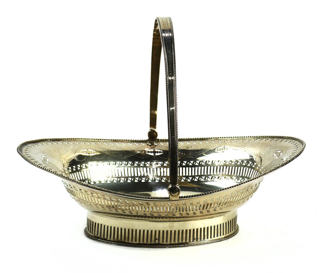 George III sterling silver swing handle basket: George III sterling silver swing handle basket, London, 1786, by John Langlands I & John Robertson I, having an oval form and a beaded lip, the pierced work sides framing a central reserve of an engra