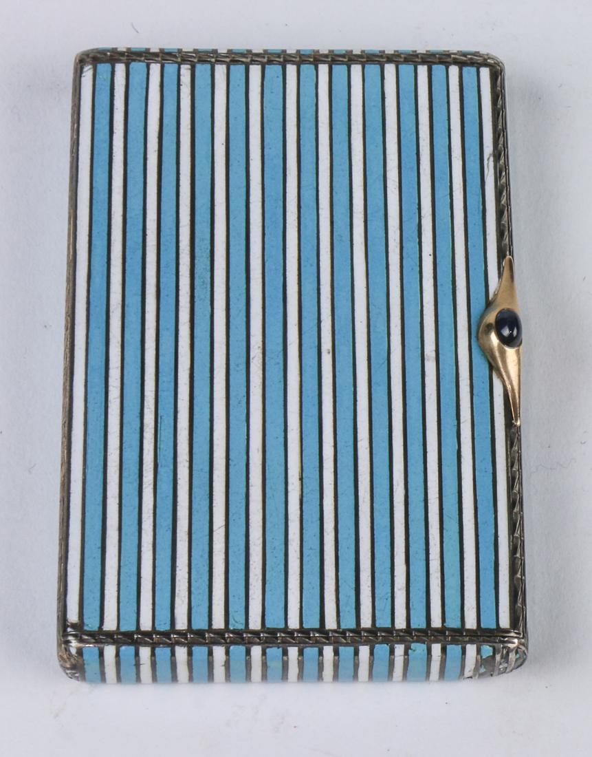 Russian: Russian .84 silver gilt and enamel cigarette case, early 20th century, the case decorated with horizontal bands of alternating blue and white enamel, the thumbpiece a small cabochon sapphire, with a g