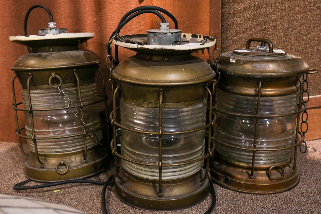 (lot of 3) Perkin's Marine Lamp Corp: (lot of 3) Perkin's Marine Lamp Corp. brass oil anchor lights, each with a clear frensel lens, (2) have been adapted with ceiling mount, now electrified as lamps, 20"h, Provenance: Property from the S