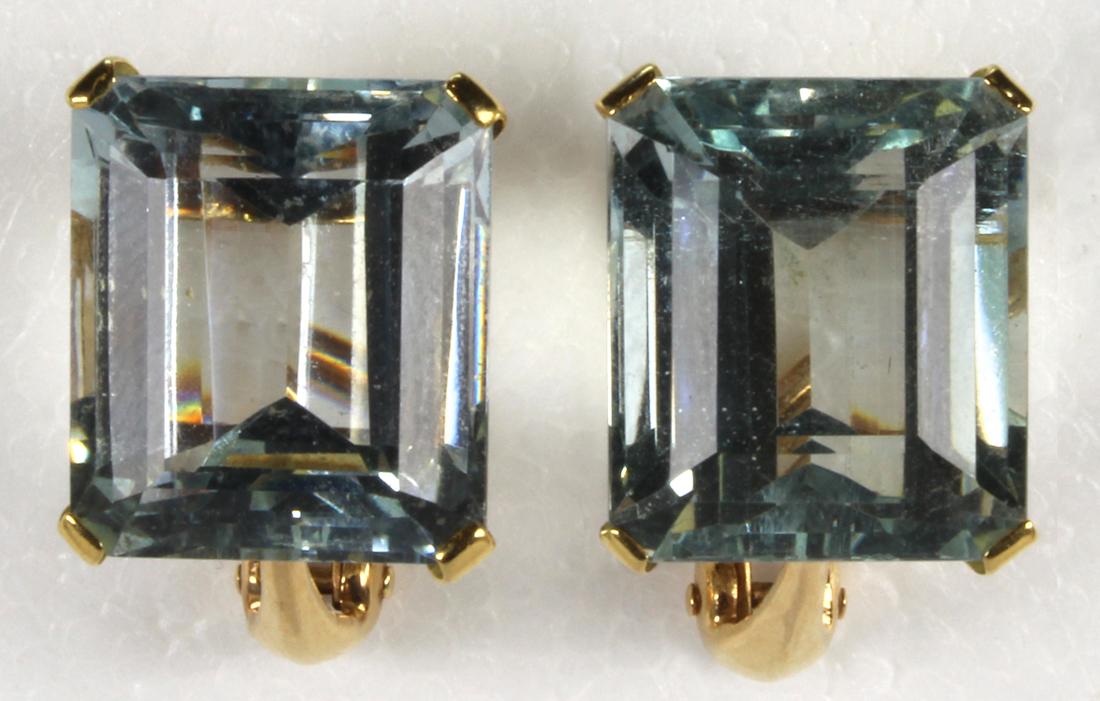 Pair of aquamarine and 14k yellow gold earrings: Pair of aquamarine and 14k yellow gold earrings Featuring (2) emerald-cut aquamarines, weighing a total of approximately 21.50 cts., set in 14k yellow gold, omega back mountings, gross weight 8.6 gram