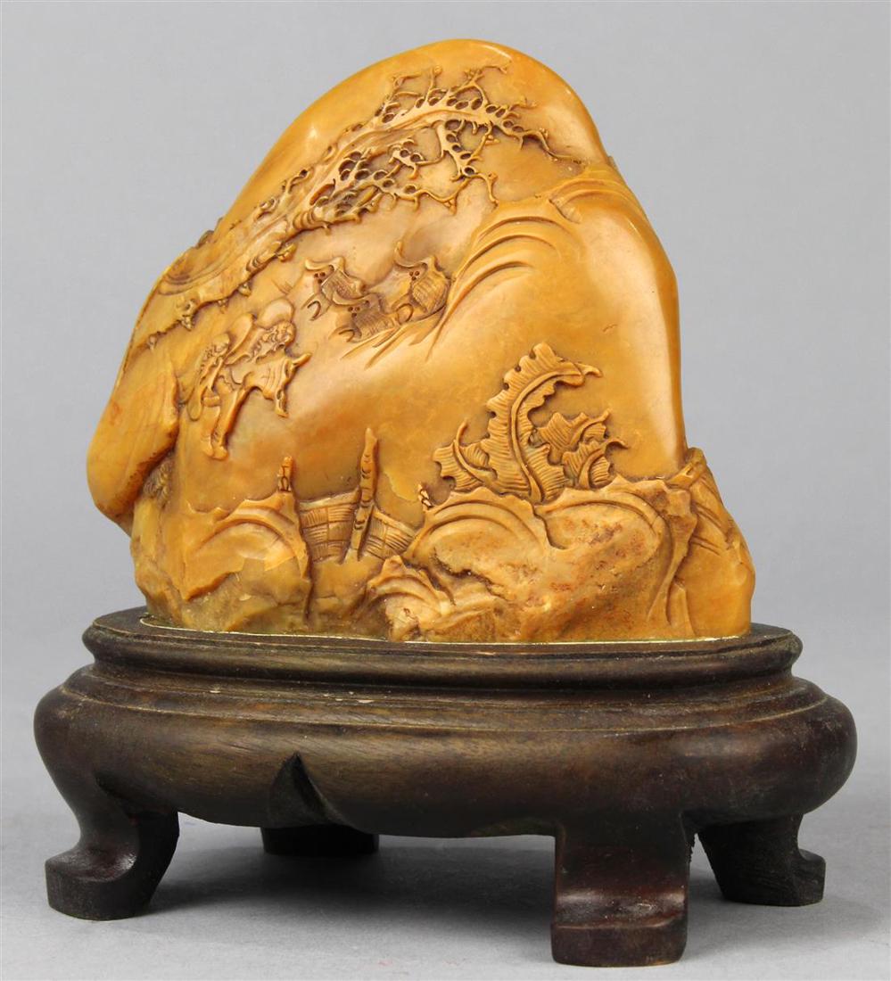 Chinese Soapstone Boulder, Figures in Landscape: Chinese soapstone boulder, both sides carved with figures travelling through landscape executed from a honey colored matrix, with wood stand, boulder: 3.75"w