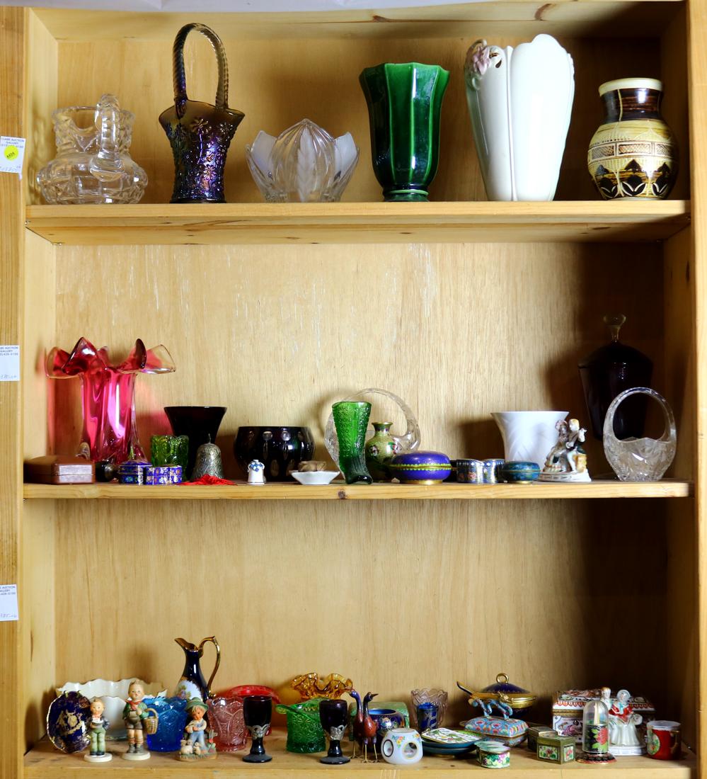 Three shelves of assorted Continental and American: Three shelves of assorted Continental and American decorative objects, including carnival glass items, pressed glass vases and baskets, cloisonne trinket boxes, figurines etc.