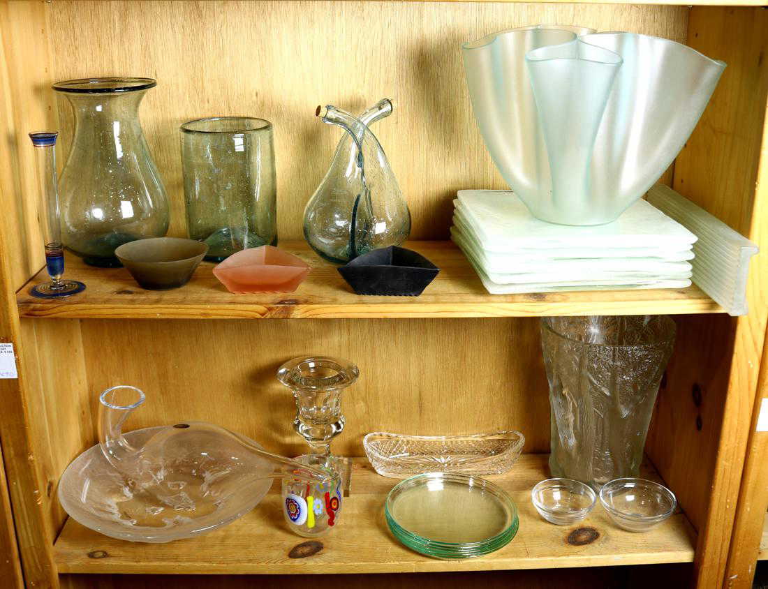 Two shelves of assorted glass decorative objects,