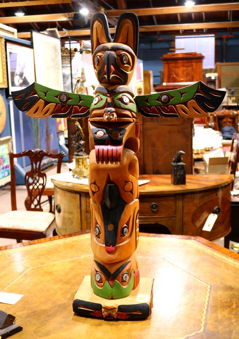 Bill Kuhnley totem pole, having polychrome decoration: Bill Kuhnley totem pole, having polychrome decoration in green and red, with mother of pearl inlay, and rising on a plinth bath, 34.5"h