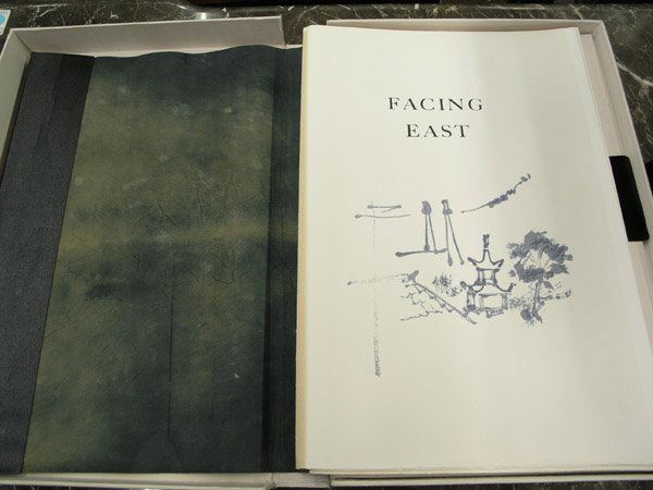 Book Jack Levine Michener Facing East: Book in white silk portfolio with black leather fastener, Facing East, by Jack Levine and James A. Michener, inside cover signed, illustrated with original lithographs and woodcuts by Jack Levine, con